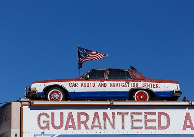 Car on the Roof of a Repair Shop