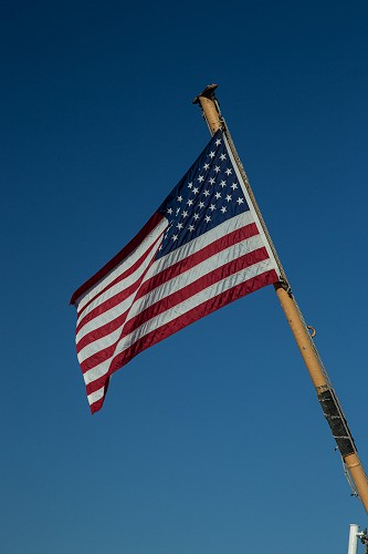 American Flag Waving in Blue Sky