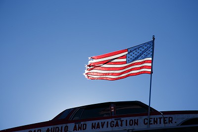 American flag Waves on the Top of an Old Car